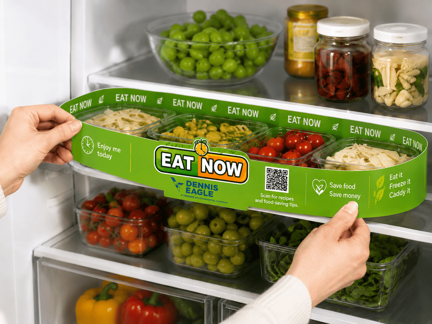 Hands applying the complete green corporate-branded rim container inside a fully stocked refrigerator shelf